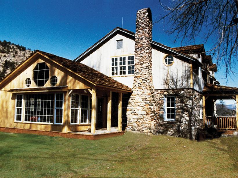Architectural home with stone accents and custom windows